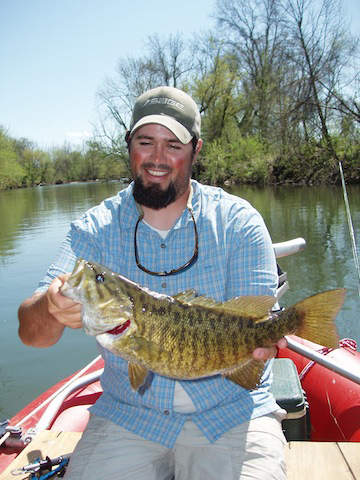 Josh Pfeiffer holding a smallmouth bass.